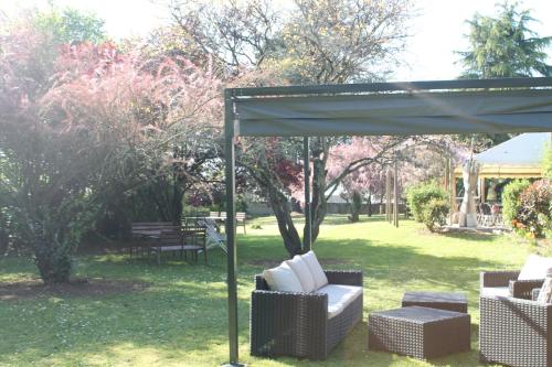 a pavilion with chairs and tables in a yard at Don Quichotte in Vallet