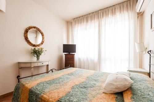 Ένα ή περισσότερα κρεβάτια σε δωμάτιο στο Residence Isola Verde Cisanello