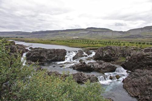 a river with rocks and waterfalls at Cabin 3 at Lundar Farm in Varmaland