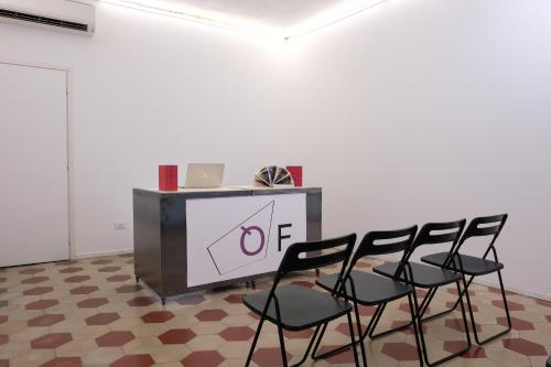 a table with four black chairs in a room at Piano Tre in Verona
