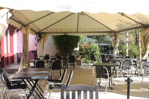a group of tables and chairs under a tent at Don Quichotte in Vallet