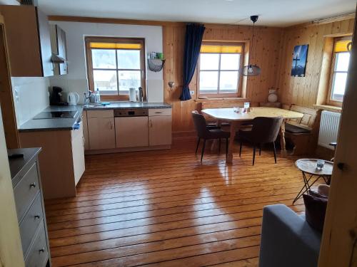 a kitchen and dining room with a table and chairs at Fasserhof in Bramberg am Wildkogel