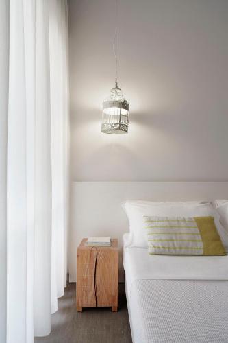 a bedroom with a bed and a night stand next to a bed sidx sidx sidx at Hotel Madison in Rimini