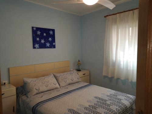 un dormitorio con una cama y una ventana en 1ere soleil levant, en Puerto Sagunto