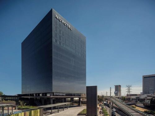 a building with a sign on the side of it at Novotel Mexico City Toreo in Mexico City