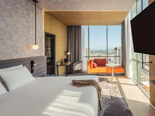 a hotel room with a bed and a balcony at Novotel Mexico City Toreo in Mexico City