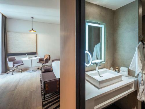 a bathroom with a sink and a mirror at Novotel Mexico City Toreo in Mexico City