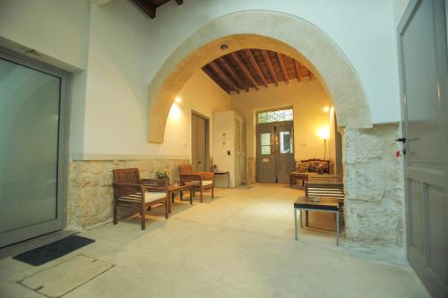 an archway in a room with tables and chairs at St. Lazaros Studios in Larnaka