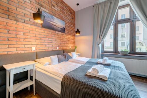 Ένα ή περισσότερα κρεβάτια σε δωμάτιο στο Apartamenty Bema4 Sopot