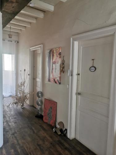 a room with a white door and a painting on the wall at Chambres d'hôtes Chez Valérie Garage motos et vélos in Arette