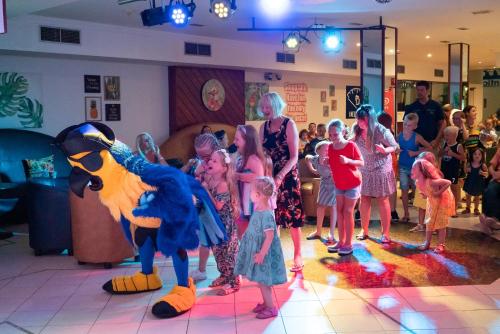 a group of children standing in a room with mascots at Apartamentos Galeon Playa in Costa Teguise