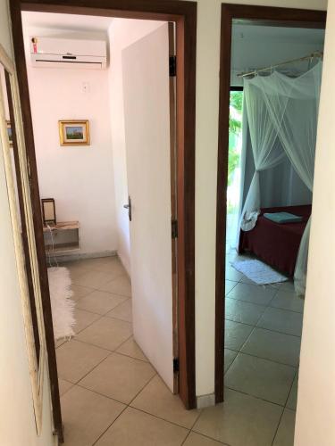 a room with a door leading to a bedroom at Ouro Sobre Azul Apart Hotel in Arraial d'Ajuda