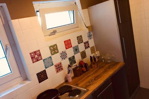 a small kitchen with a sink and a window at Haus im Garten „zentral und doch sehr ruhig“ in Elten
