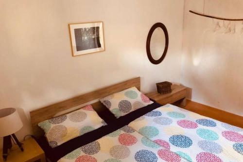 a bedroom with a bed and a mirror on the wall at Haus im Garten „zentral und doch sehr ruhig“ in Elten
