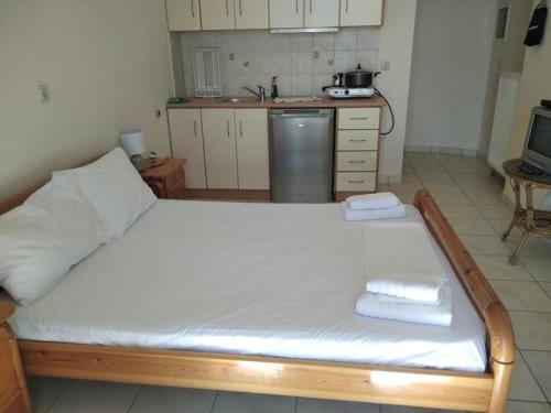 a large bed in a kitchen with towels on it at Gorgones, sea-front, great view in Kardamili