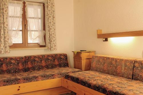 a living room with a couch and a window at Erlebnisgastronomie Lochmuhle in Eigeltingen