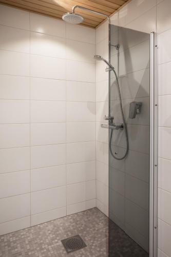 a bathroom with a shower with a glass door at Santa Claus Holiday Village in Rovaniemi