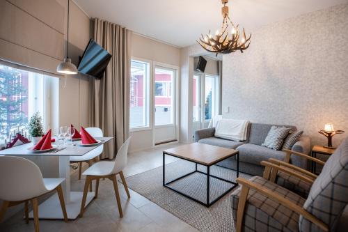 a living room with a couch and a table at Santa Claus Holiday Village in Rovaniemi