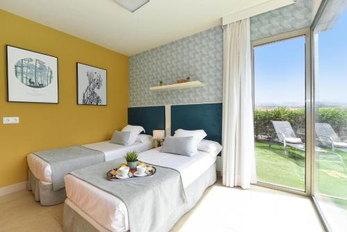 a hotel room with two beds and a window at Albatross by VillaGranCanaria in Maspalomas