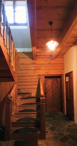 a stairway in a house with a wooden ceiling at Koliba Valaška in Trojanovice