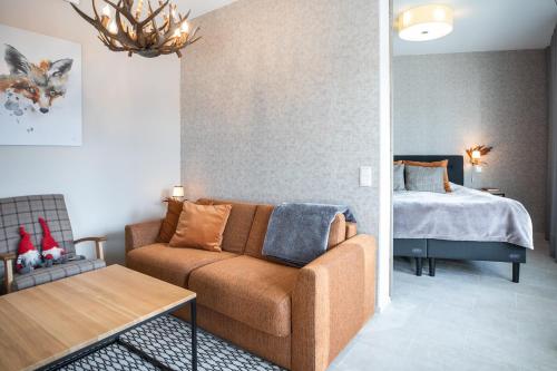 a living room with a couch and a bed at Santa Claus Holiday Village in Rovaniemi