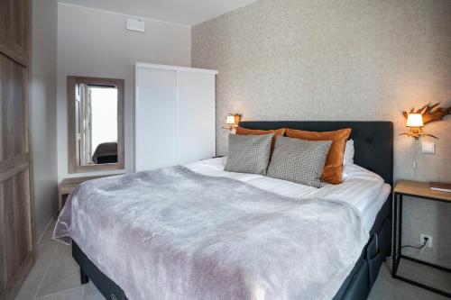 a bedroom with a large bed with two pillows at Santa Claus Holiday Village in Rovaniemi