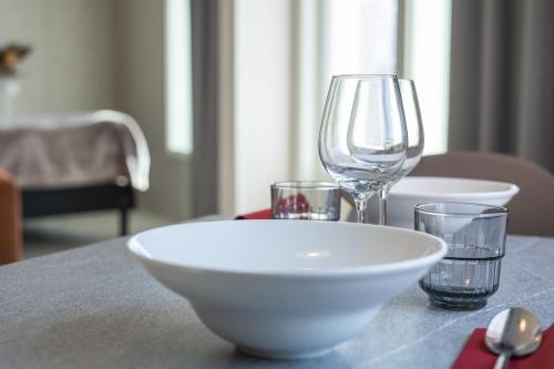 a white bowl and two glasses on a table at Santa Claus Holiday Village in Rovaniemi