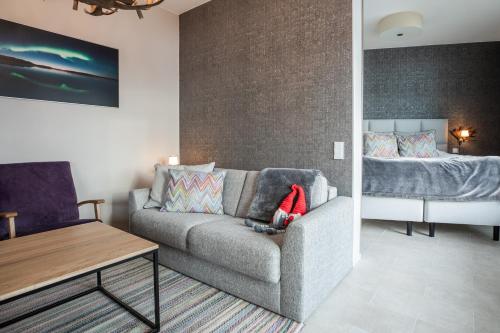 a living room with a couch and a bed at Santa Claus Holiday Village in Rovaniemi