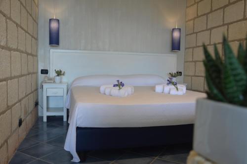Postel nebo postele na pokoji v ubytování CapoSperone Resort