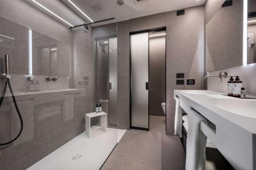 a bathroom with two sinks and a shower at J44 Lifestyle Hotel in Lido di Jesolo