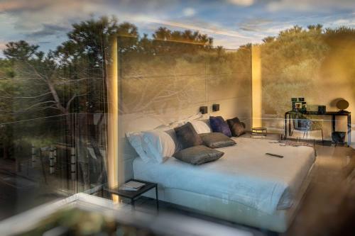 a bedroom with a large bed in front of a window at J44 Lifestyle Hotel in Lido di Jesolo