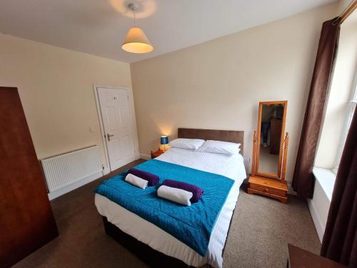 a bedroom with a large bed with two pillows on it at The Boat Yard in Appledore