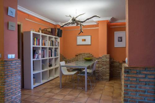 a dining room with a table and bookshelves at Casa vacaciones in Castellón de la Plana