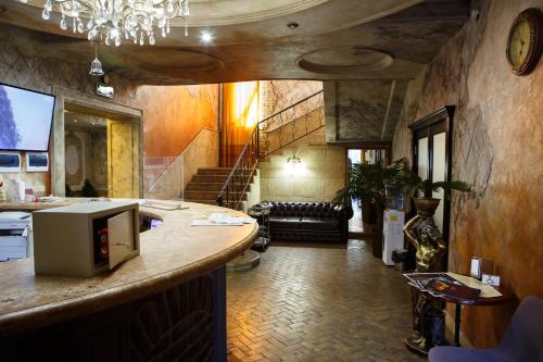 a kitchen with a counter and a living room at Misteriya Hotel in Kharkiv