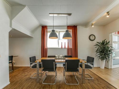 een eetkamer met een tafel en stoelen bij Classy Holiday Home in Langezwaag with Terrace in Langezwaag