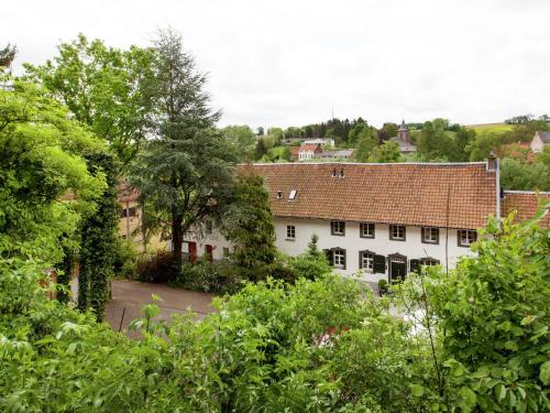 an aerial view of a white house with trees at Scenic Gulp Valley Stay in Slenaken