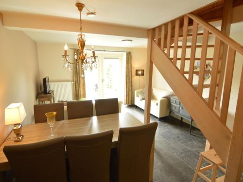 a dining room with a table and chairs and a staircase at Holiday Home in Slenaken near Forest in Slenaken