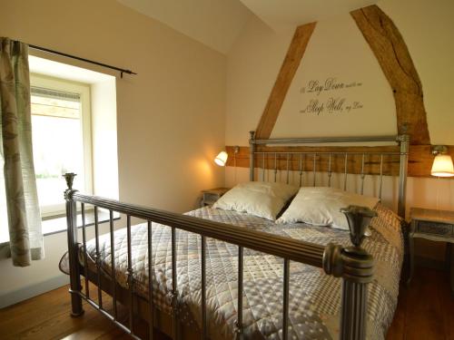 a bedroom with a bed with a wooden headboard at Holiday Home in Slenaken near Forest in Slenaken