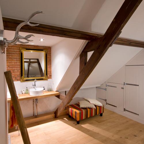 a bathroom with a sink and a mirror at Villa Polder - Boutique Hotel near Eindhoven in Gemert