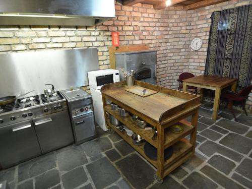 a kitchen with a stove and a table in it at Holiday Home in Wellerlooi with Private Garden in Wellerlooi