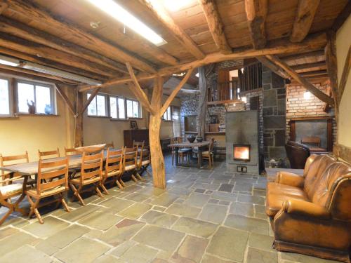 een grote kamer met een tafel en stoelen en een open haard bij Holiday Home in Wellerlooi with Private Garden in Wellerlooi