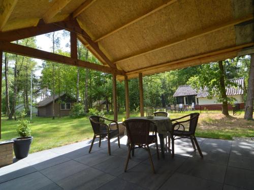 a patio with a table and chairs under a pavilion at Holiday Home in Stramproy near Nature Reserve in Stramproy