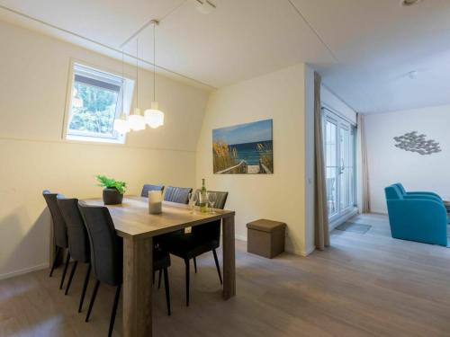 a dining room and living room with a table and chairs at Luxurious Apartment in Koudekerke near Beach in Koudekerke