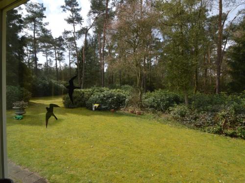 two statues of people playing in a yard at Beautiful Holiday Home with Garden in Huijbergen in Huijbergen