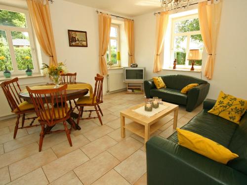 een woonkamer met een bank en een tafel bij Restored farmhouse in Wijlre with two terraces in Wijlre