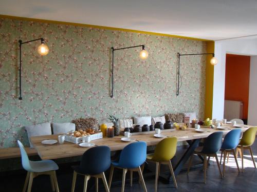 a dining room with a long table and chairs at These two holiday homes built in 2006 in Zuidzande