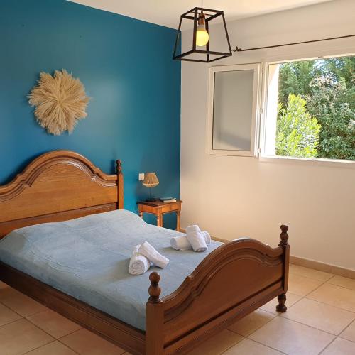 une chambre avec un lit aux murs bleus et une fenêtre dans l'établissement Villa Ribba 6 pers piscine 5 min plage en voiture, à Gialla