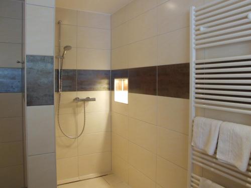 a bathroom with a shower with a glass door at Boutique Hotel Wolfsburg in Wolfsburg