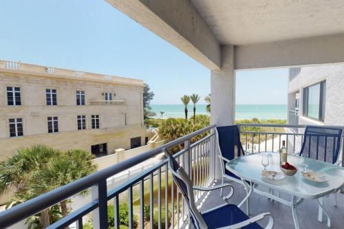 a balcony with a table and chairs and a building at Siesta Sands Beach Resort 4th Floor with Elevator in Sarasota