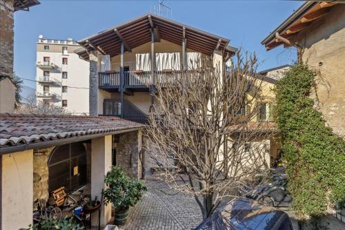 an apartment building with a balcony and a tree at I Balconi in Iseo